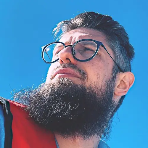 a man with a beard and glasses