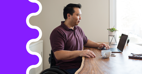 a man sitting at a table with a laptop