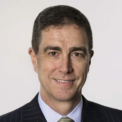 a man in a suit smiling
