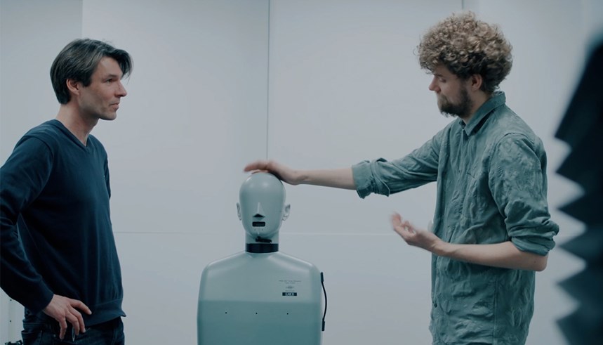 a man pointing at a man using a white machine