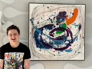Emmett Kyoshi posing with artwork