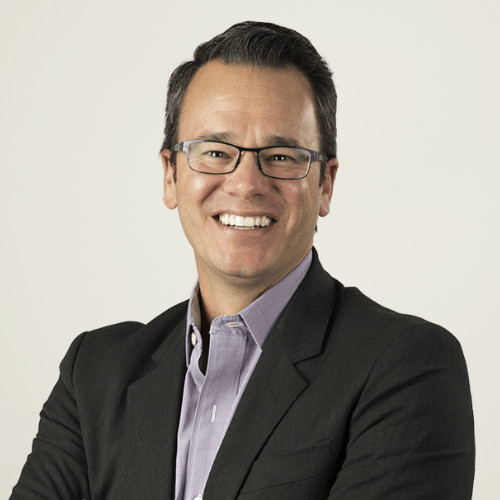 a man wearing glasses and a suit