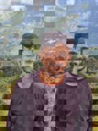 a man smiling with a valley in the background