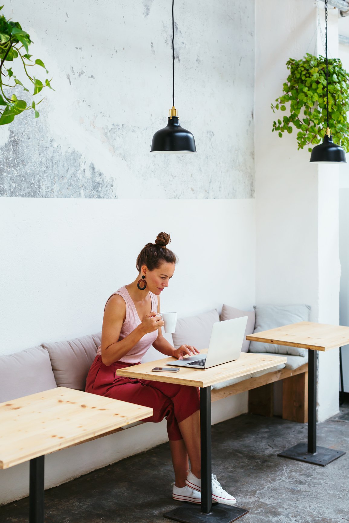 a person sitting at a table with a laptop