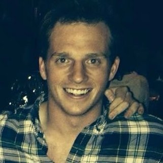 a man smiling with his hand on his chin