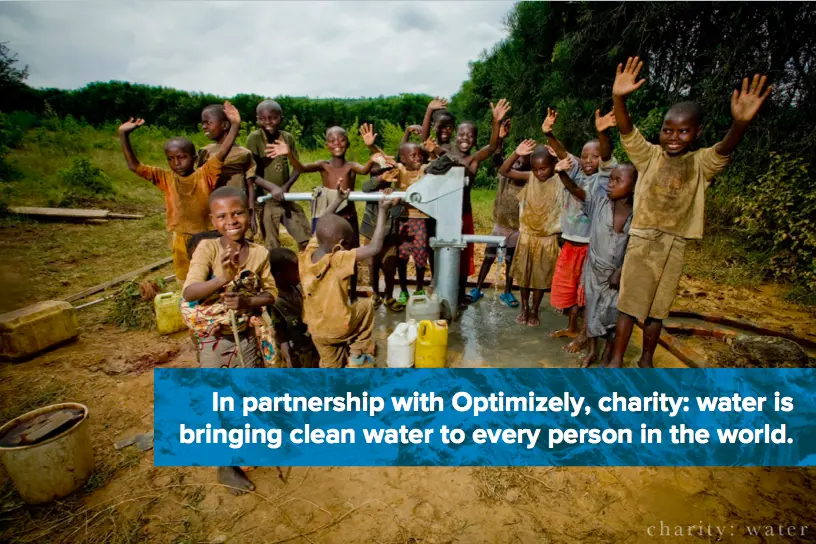 Happy children near Charity:Water pump