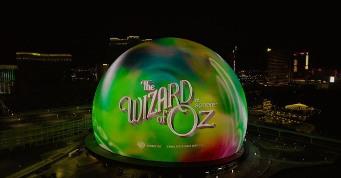 a green ball with a city in the background