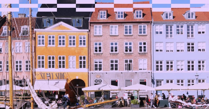 a group of buildings with people walking around