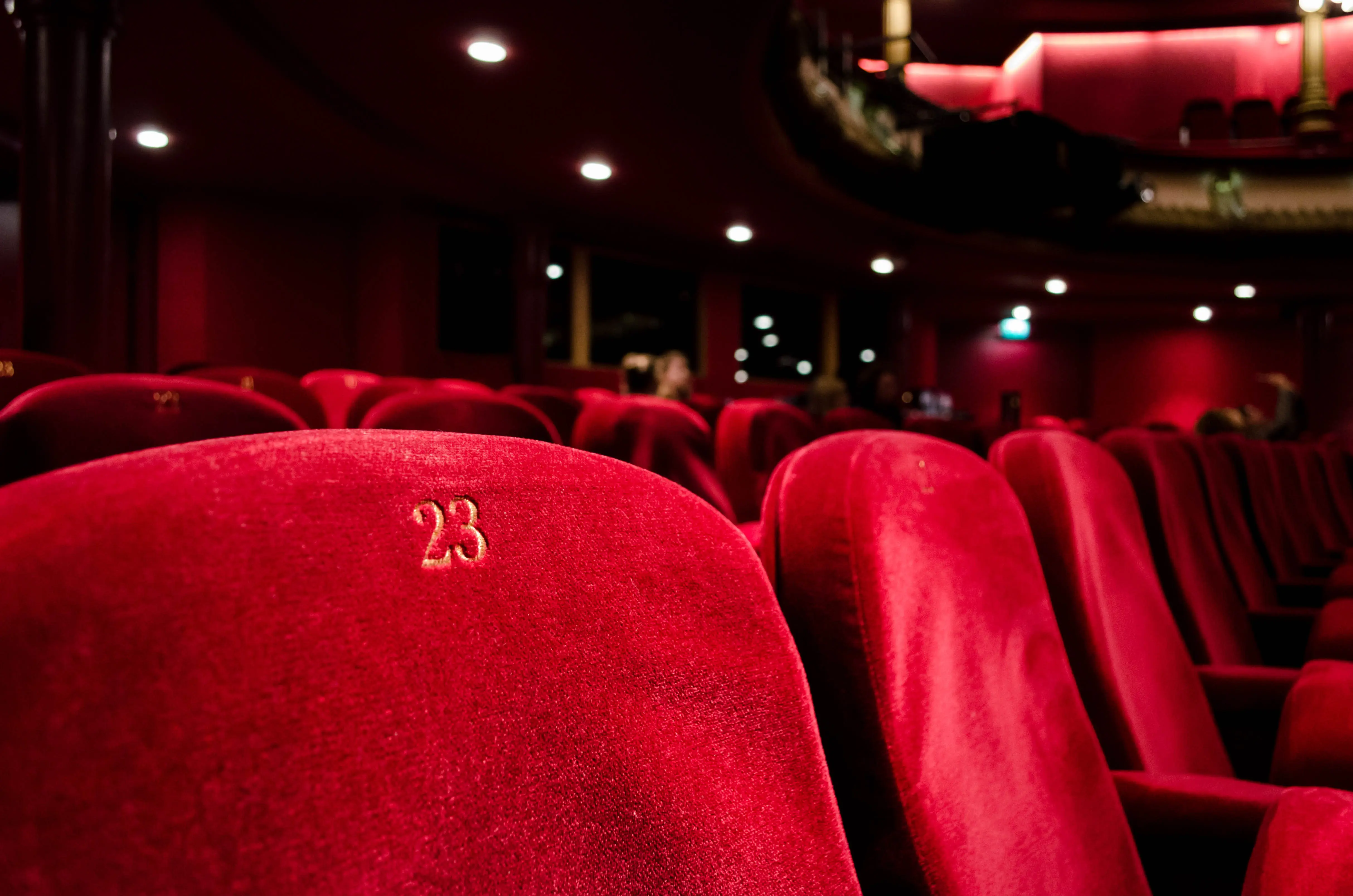 a large theater with red seats