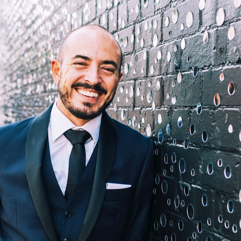 a man in a suit smiling
