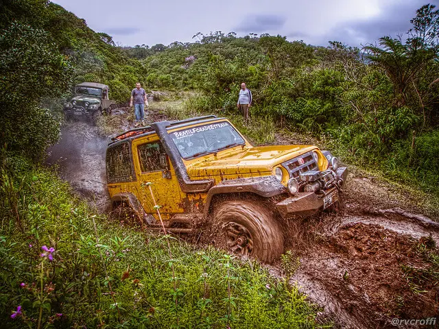 a yellow car on a muddy road