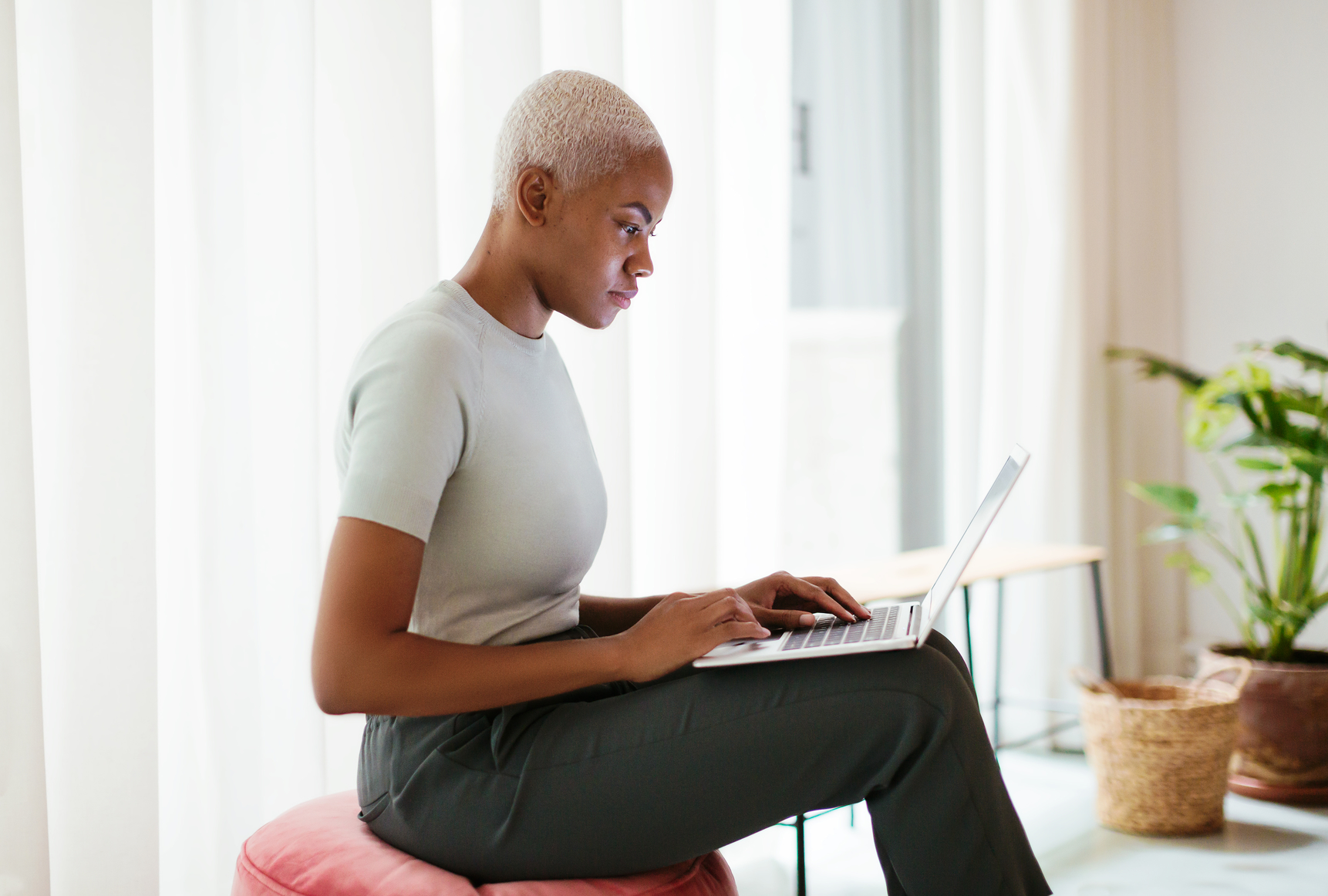 a man sitting on a chair using a laptop