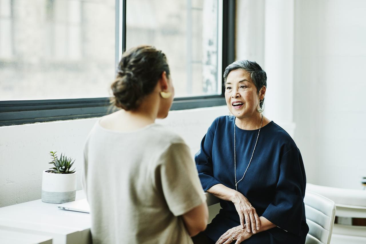 a person talking to another woman