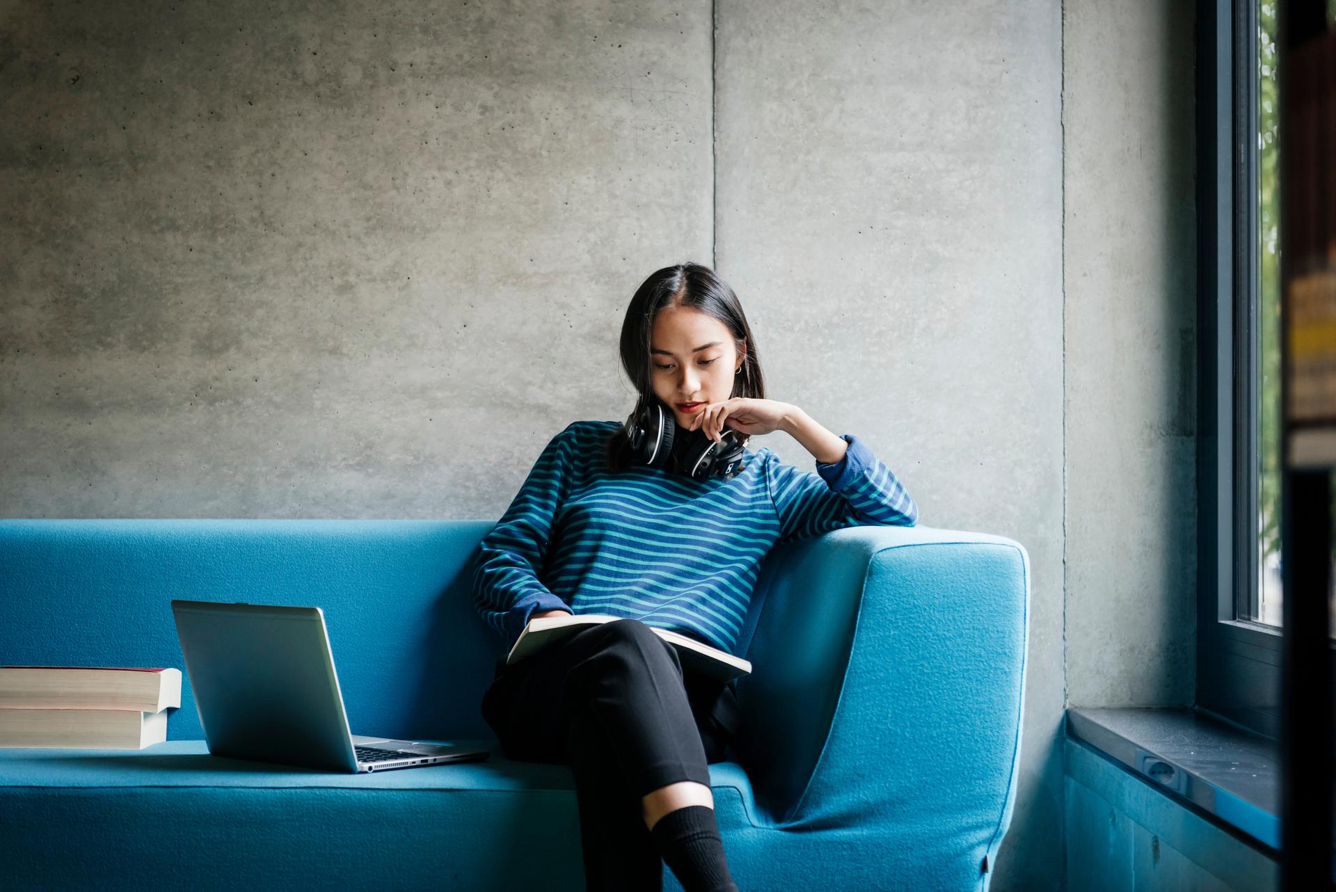 a woman sitting on a blue chair