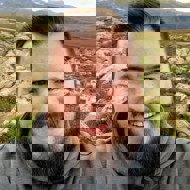 a man with a beard smiling