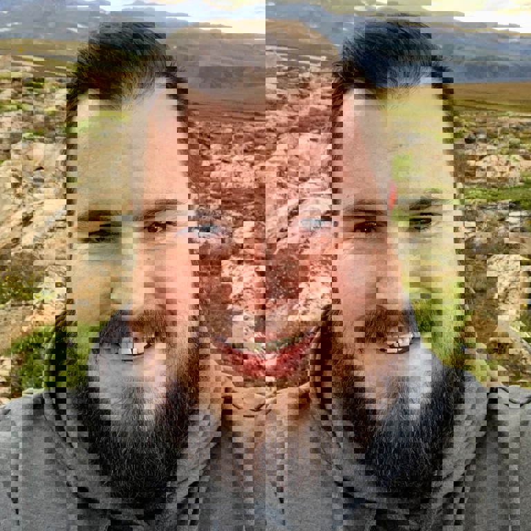 a man with a beard smiling