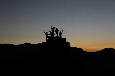 a group of people standing on a rock formation