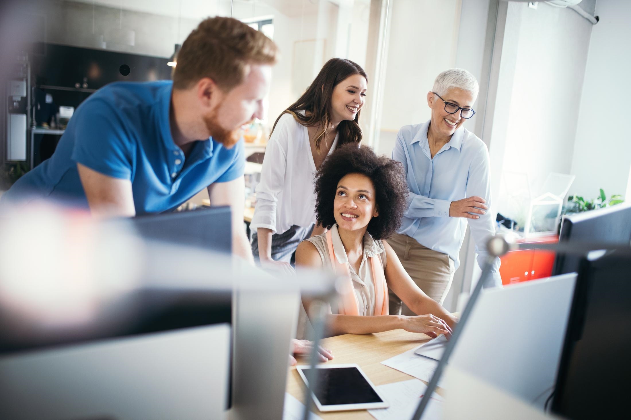 a group of people looking at a computer screen